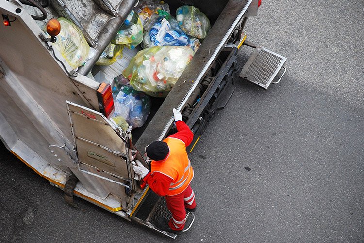 Garbage man at work on the truck 