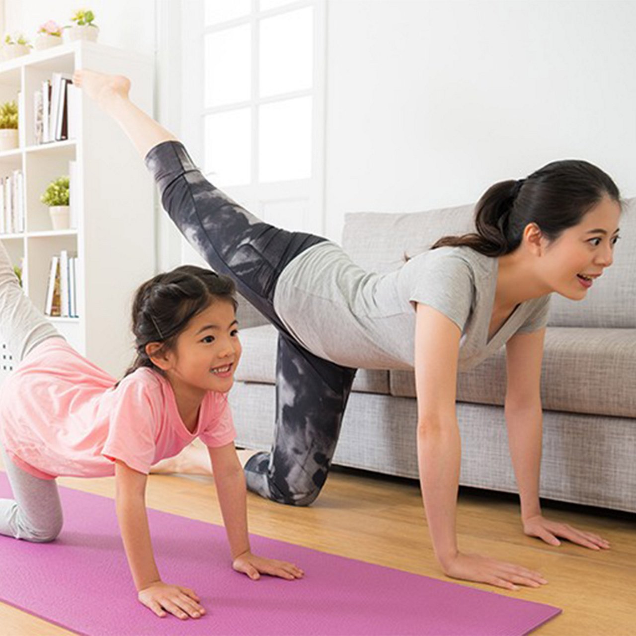 Mother and daughter doing yoga