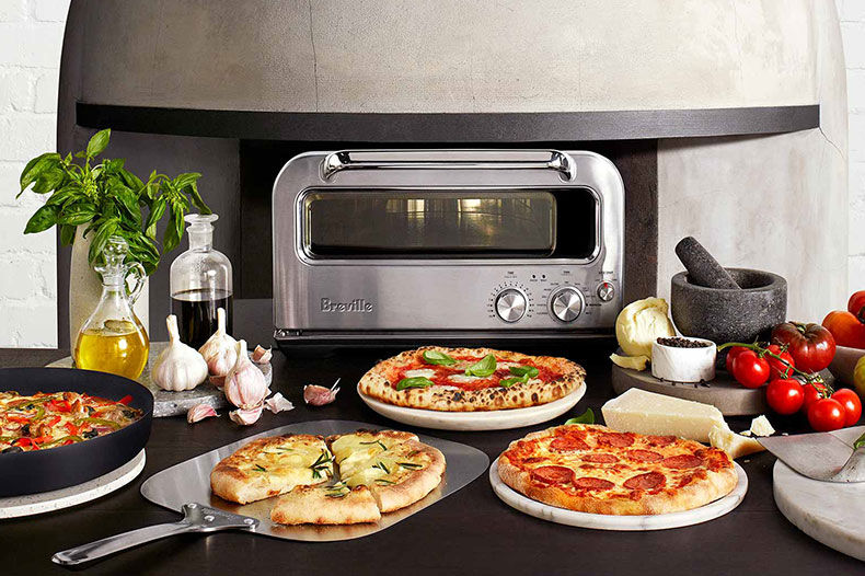 the Smart Oven® Pizzaiolo displaying three freshly cooked pizzas