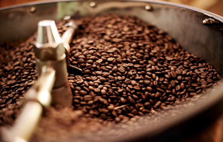 Darkly roasted beans in coffee mixer