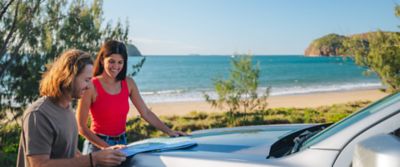 Couple looking at map on shorefront at Yepoon