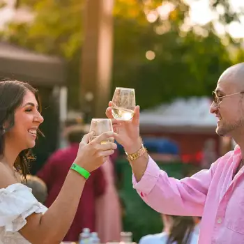 Couple cheers their wine glasses at Capricorn Food and Wine Festival in Rockhampton Couple cheers their wine glasses at Capricorn Food and Wine Festival in Rockhampton
