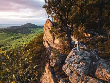 Couple stand on the sandstone escarpment at Wallaroo Station