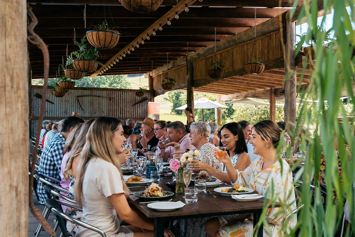 Diners sitting around a table eating at Noosa Eat & Drink Festival Diners sitting around a table eating at Noosa Eat & Drink Festival