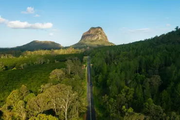 Driving through the lush landscape with Mount TIbrogargan in the background | Sunshine Coast road trip Driving through the lush landscape with Mount TIbrogargan in the background | Sunshine Coast road trip