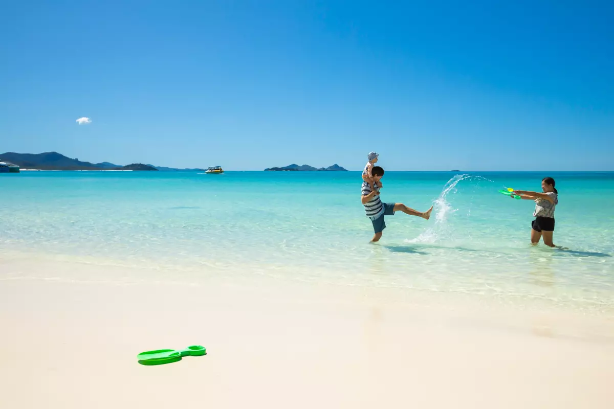 Family playing at Whitehaven Beach, Whitsunday Island | beautiful beaches Queensland Family playing at Whitehaven Beach, Whitsunday Island | beautiful beaches Queensland