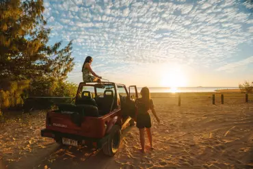 Friends enjoying sunset on car from Arcadia Beach Guest House and Car Hire Friends enjoying sunset on car from Arcadia Beach Guest House and Car Hire