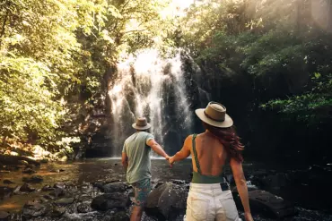 Couple holding hands in front of Ellinjaa Falls