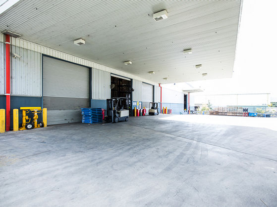 Image of warehouse exterior showing hardstand, awning and roller doors