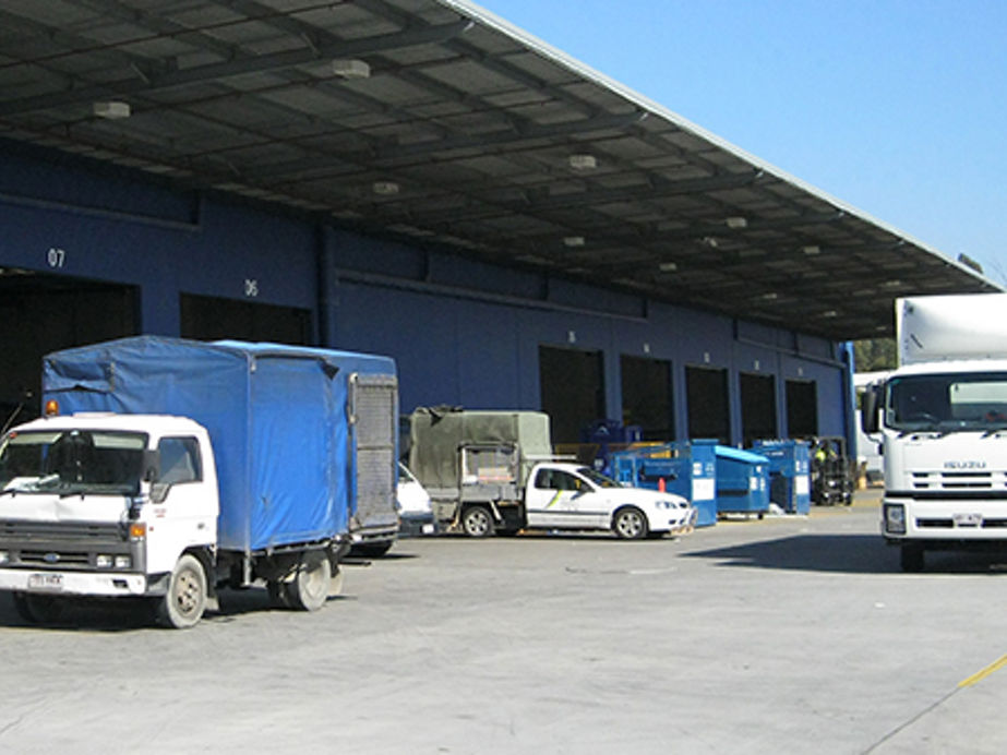 Exterior image of warehouse with awning and roller doors