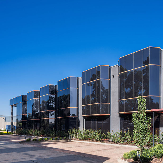 Image of warehouse exterior with car parking 
