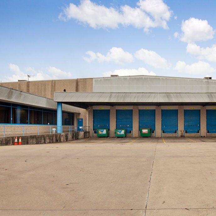 Exterior image of 46 Airds Road industrial facility warehouse with loading dock doors and awning
