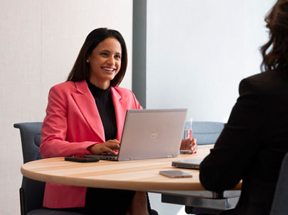 Woman in a meeting wearing a pink blazer 