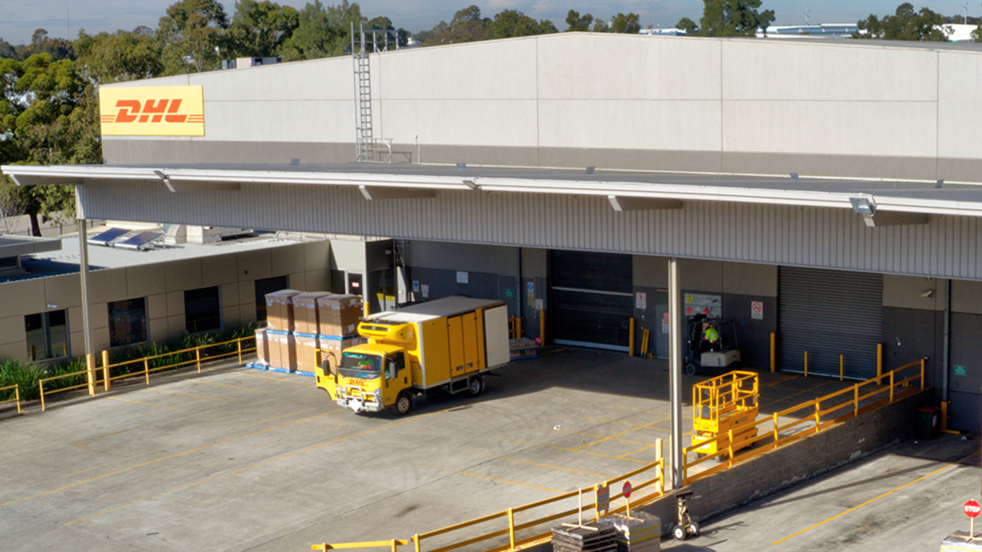 Exterior image of 52 Holbeche Road distribution centre loading dock with DHL overhead signage 