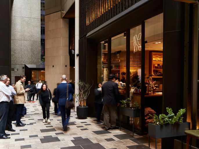 people outside cafe in 80 Collins Street precinct