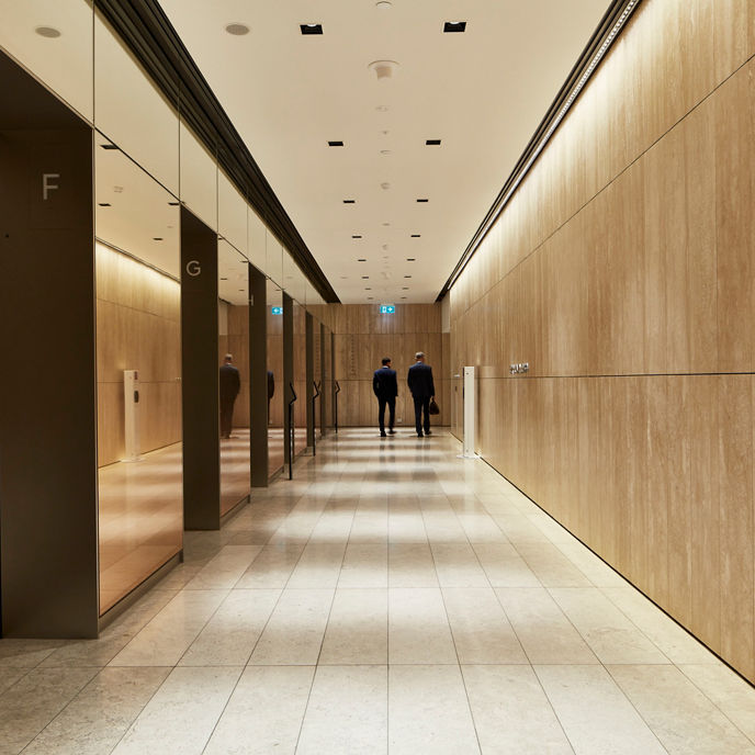 People walking towards lifts