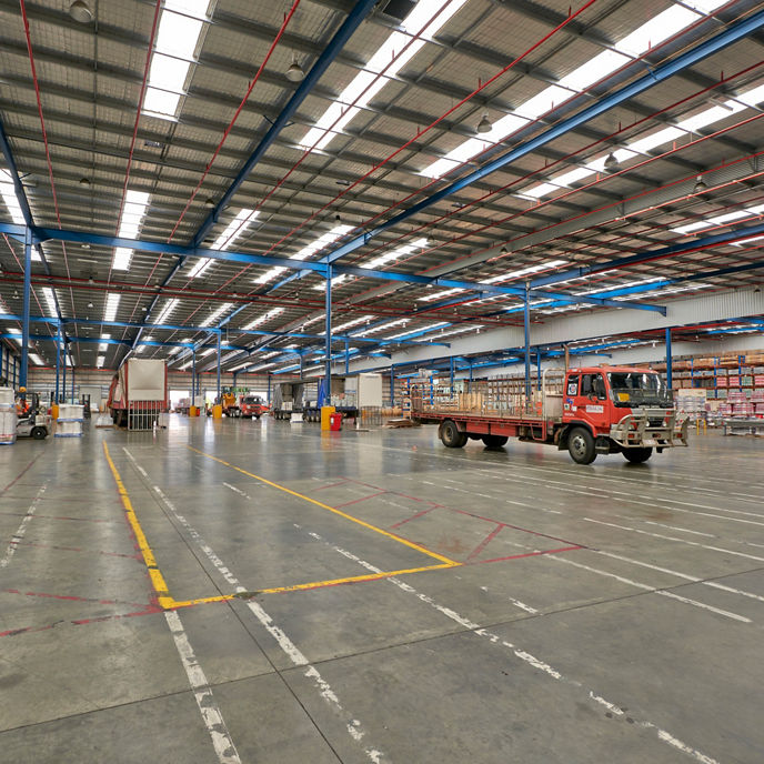 Interior image of 90 Mills Road industrial and logistics warehouse facility with trucks and pallets of materials 