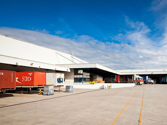 Wide angle exterior image of 93 Williamson Road loading bays with trucks 