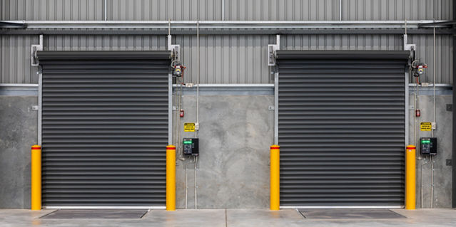 Two black industrial roller doors