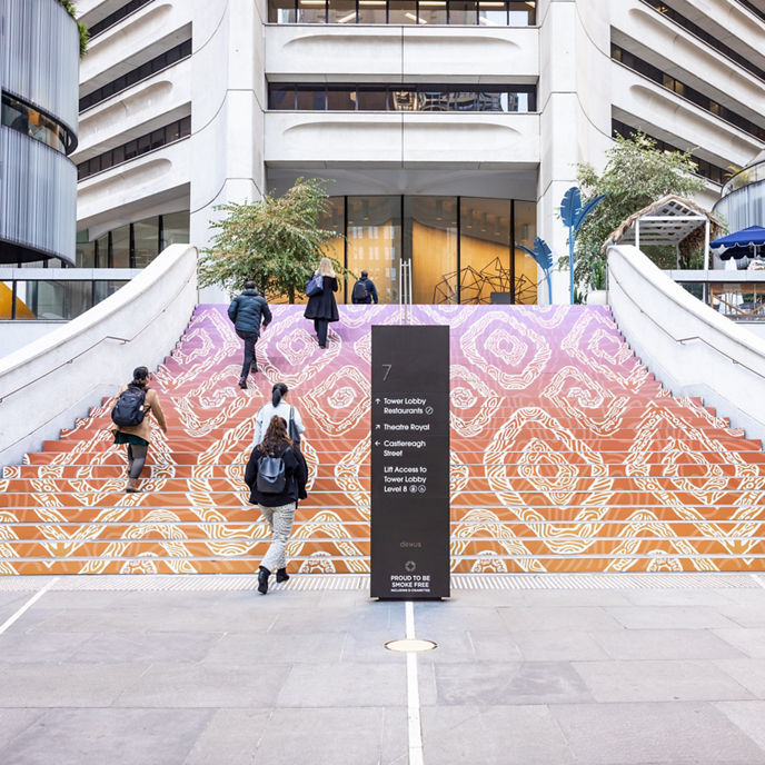 Exterior image of 25 Martin Place entry steps with First Nations art installation and building totem signage 