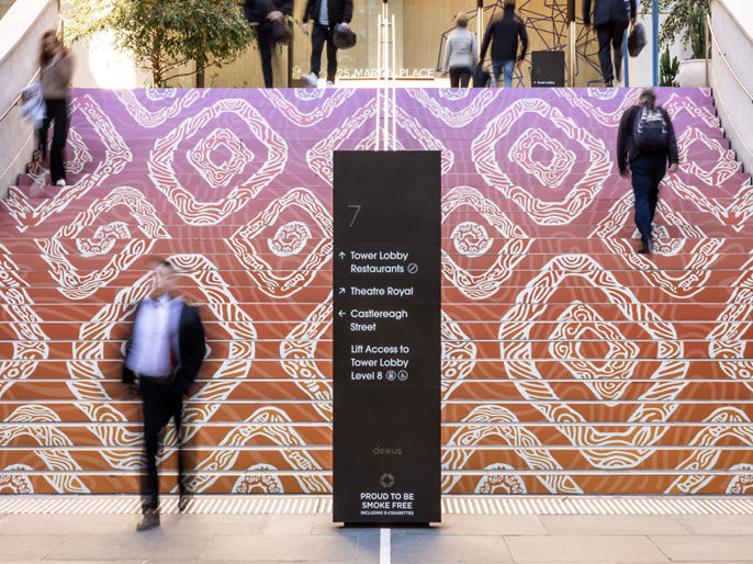 Exterior image of 25 Martin Place office tower entry steps with First Nations art installation and building totem signage 