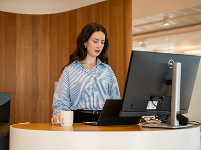 Woman in a meeting wearing a pink blazer 