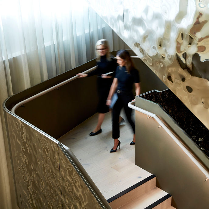 Two women walking downstairs