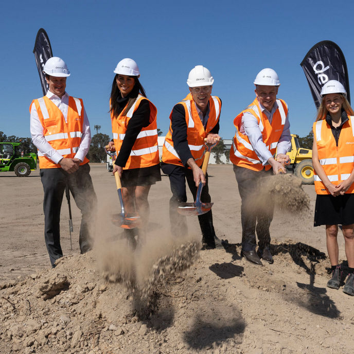 Dexus employees in high vis vests with shovels
