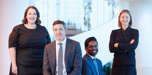 Four people in corporate clothing 