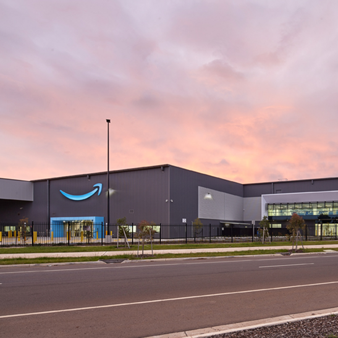 Exterior image of Amazon facility with sunset sky