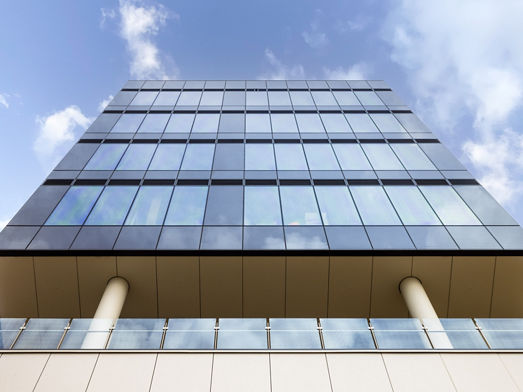 Looking up at the glass exterior of North Shore Health Hub