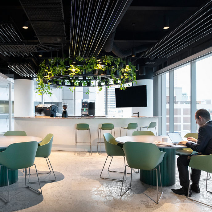 Interior image of 3 women working within flexible working facilities with couches, chairs and tables  