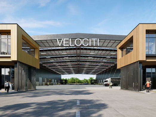 Artist impression of a road between two buildings with a “Velociti” sign above the road