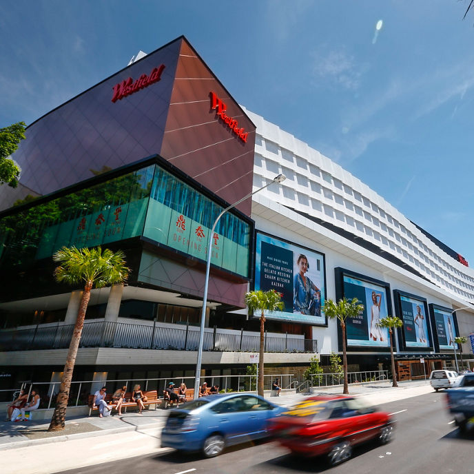 Outside the front of Indooroopilly Shopping Centre with people sat in cafes