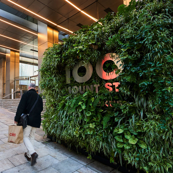 Exterior image of 100 Mount Street office tower pedestrian entrance and building signage 