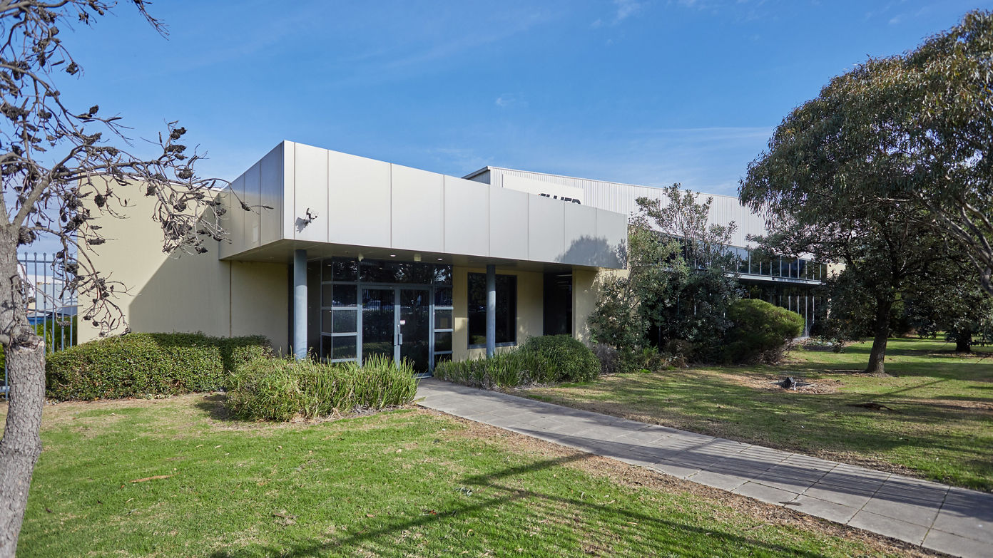 Exterior image of 202-228 Greens Road office space pedestrian entry within landscaping