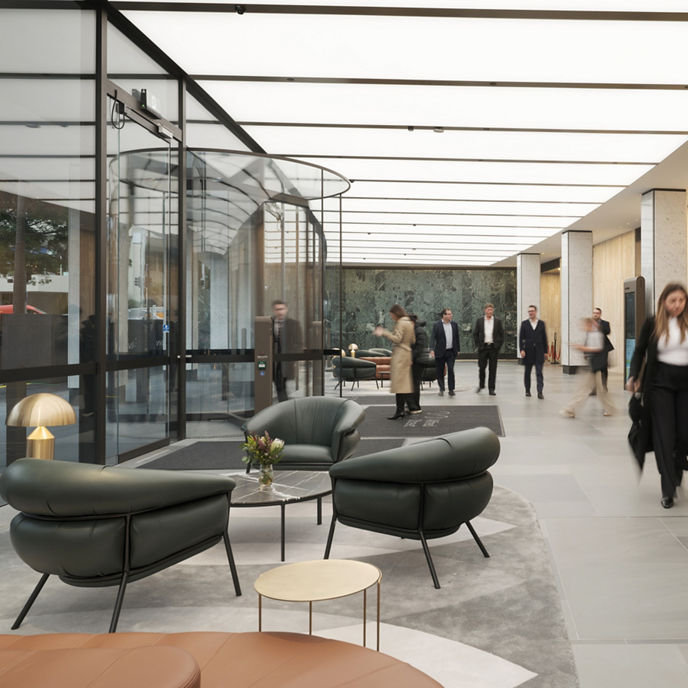 A concierge and customer at a marble lobby desk at 123 Albert Street