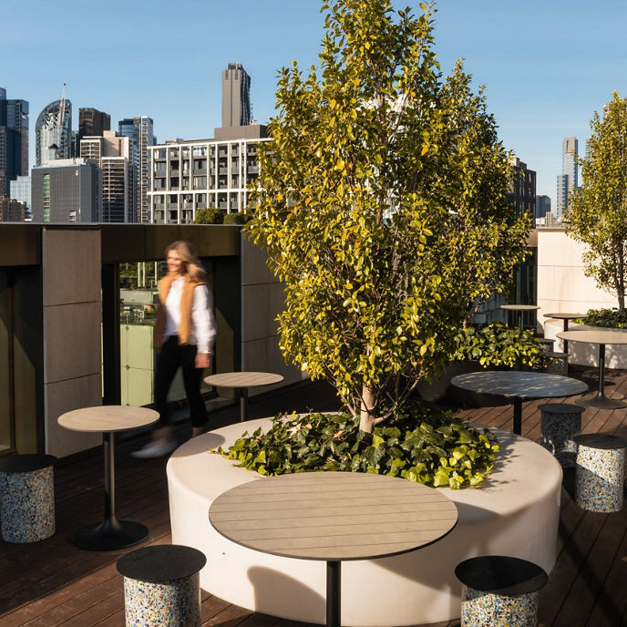 A woman walking through a garden rooftop at University of Melbourne