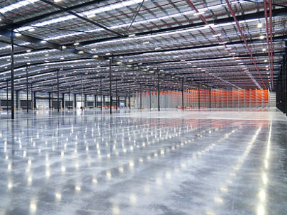 Inside a bright, expansive, empty warehouse