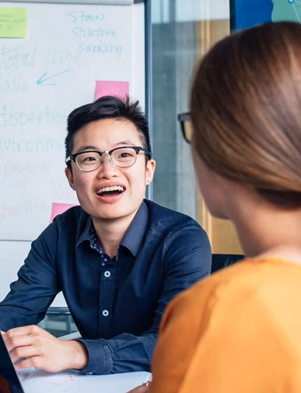 employees laughing and smiling in an office space