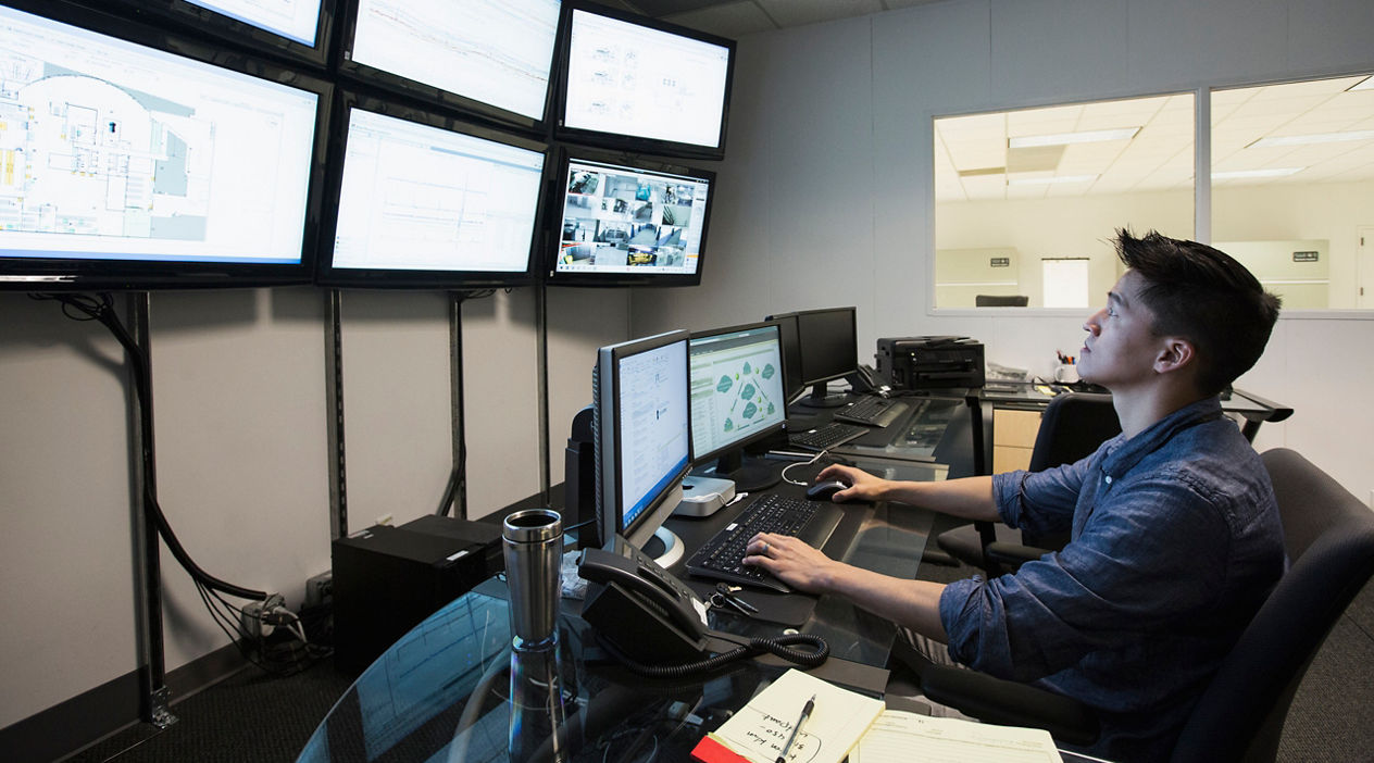 Chinese businessman working in control room