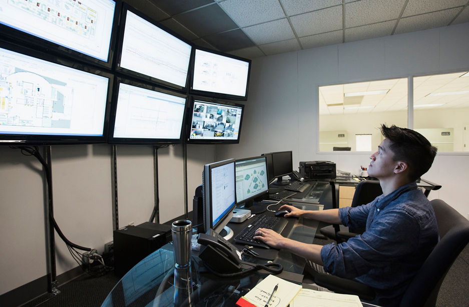 Chinese businessman working in control room