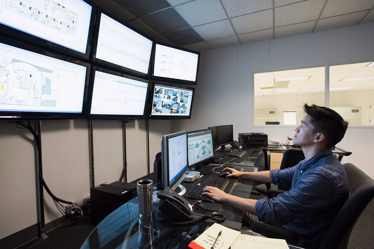 Chinese businessman working in control room
