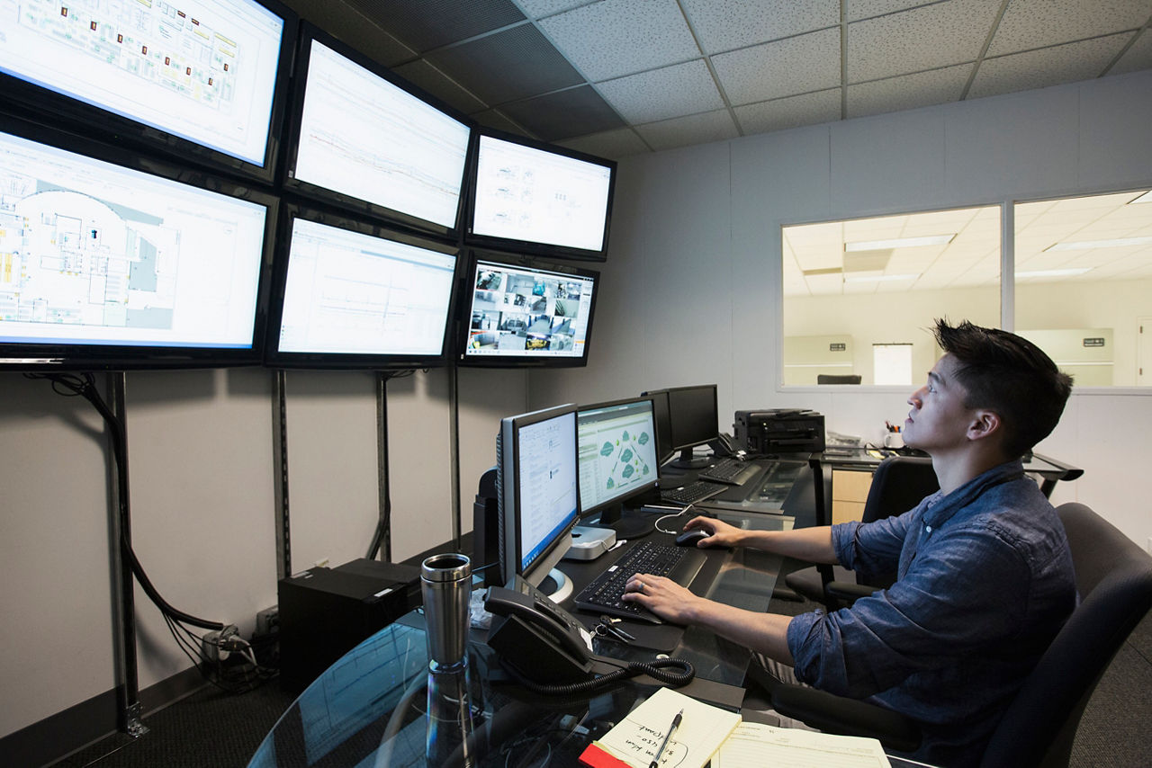 Chinese businessman working in control room