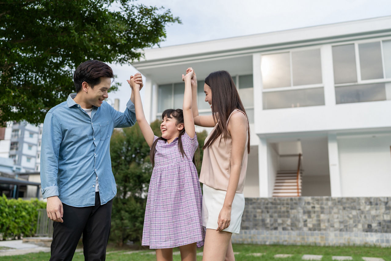 Asian loving parents playing with young daughter outdoors in the garden. Happy family attractive couple and little girl feel relax and enjoy spend time in backyard at home. Family-Relationship concept