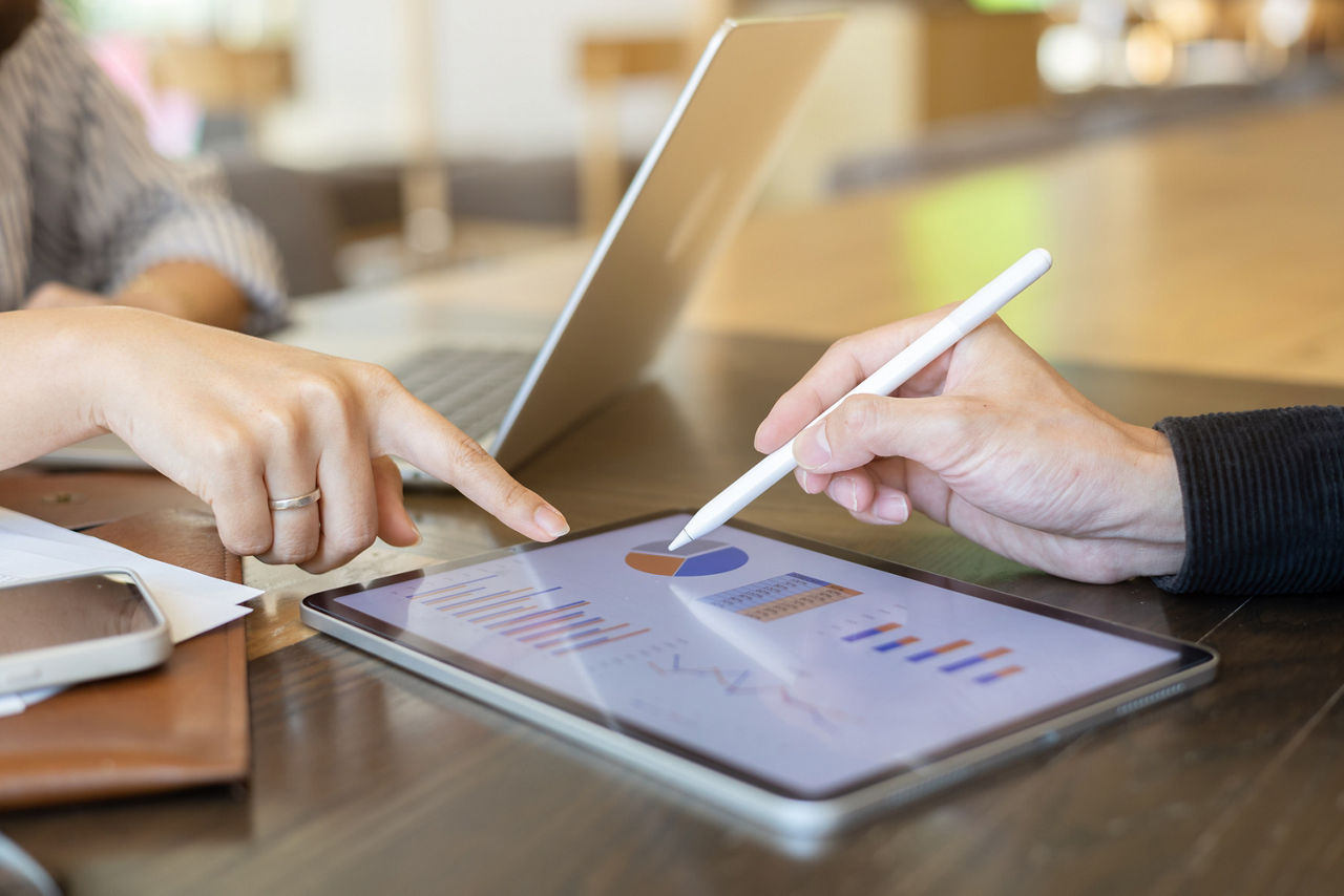 close up ceo businessman hand use stylus pen to point on dashboard screen tablet device for ask and share idea or consulting with businesswoman partner for business teamwork concept