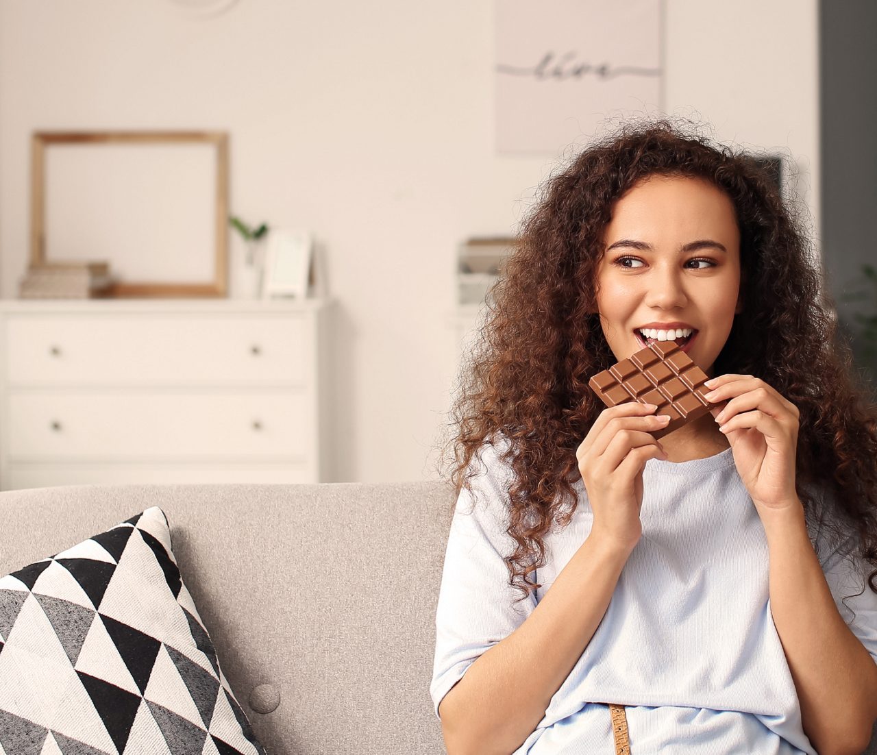 Young woman eating chocolate