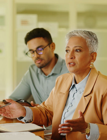 Senior, woman or business people in meeting with talking in teamwork for creative decision making. Collaboration, manager or professional employees with paperwork for project brainstorming in office.