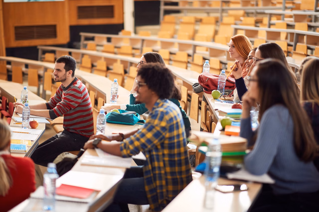 Young students focused on lecture in amphitheater