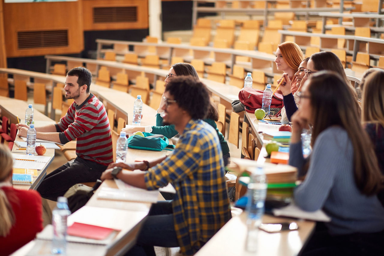 Young students focused on lecture in amphitheater